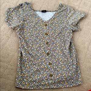 A floral button top, it’s very flowy